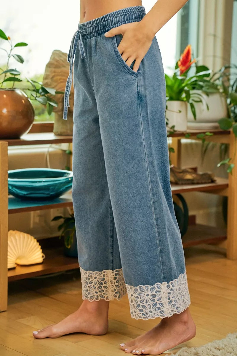 Washed denim pull-on pants with drawstring and flower lace trim at the bottom hems