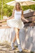 Ivory knife-pleat mini skirt with high waist and smooth lining