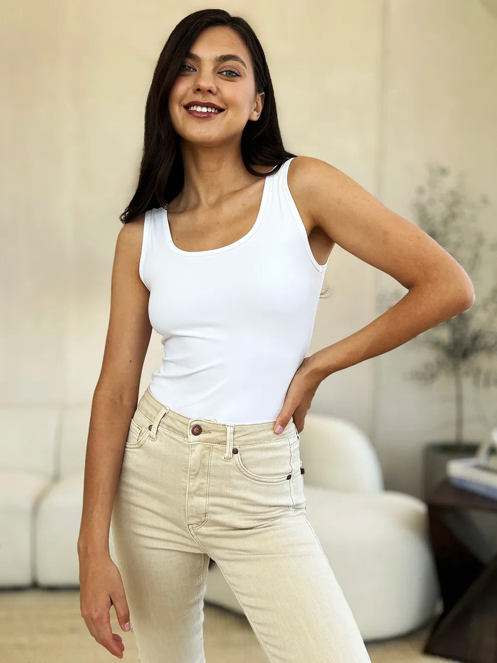 White sleeveless bodysuit, front view with crew neckline and fitted torso