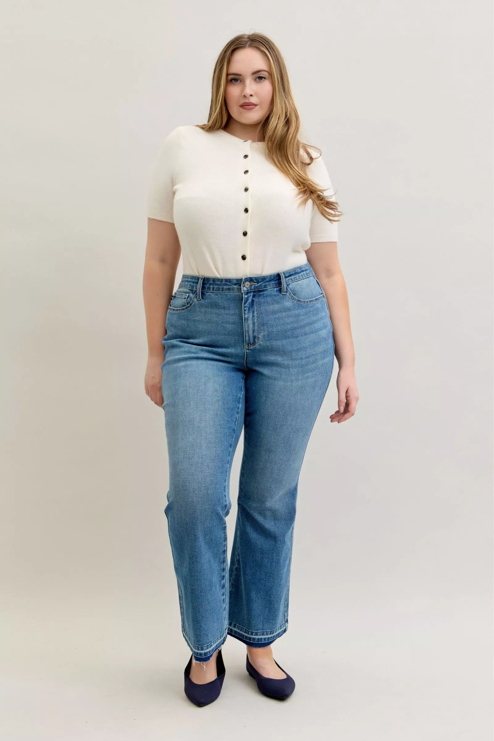 Plus size light blue mid-rise jeans with button closure and back yoke seams