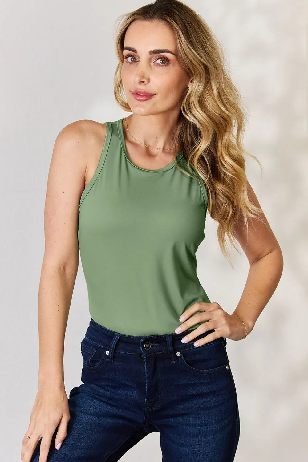 Light green round-neck racerback tank top with smooth front and sleeveless fit