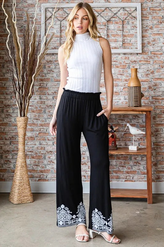 Black wide-leg casual pants with elastic waist and damask print at leg hems