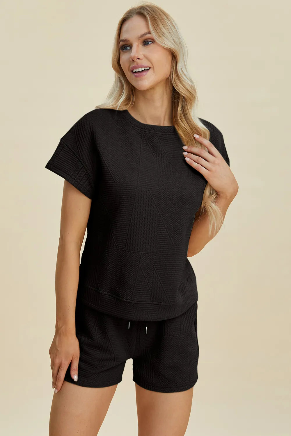 Black textured short-sleeve top with matching drawstring shorts set.