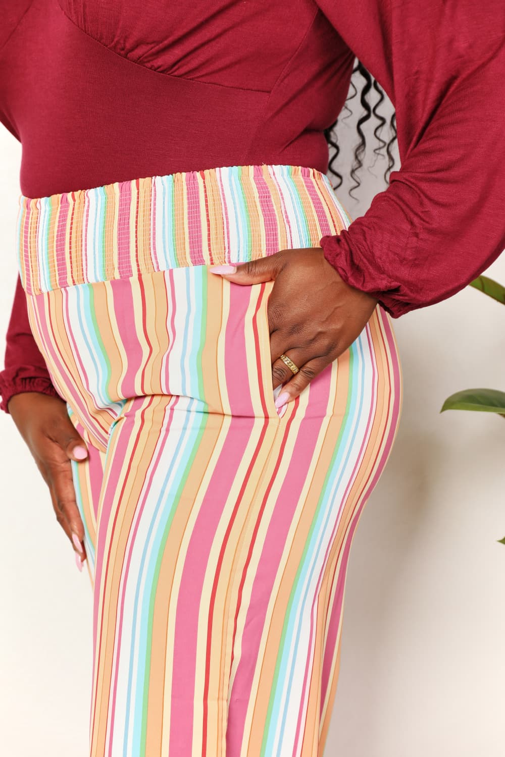Multicolor striped smocked-waist pants with pockets, fitted waist and straight legs