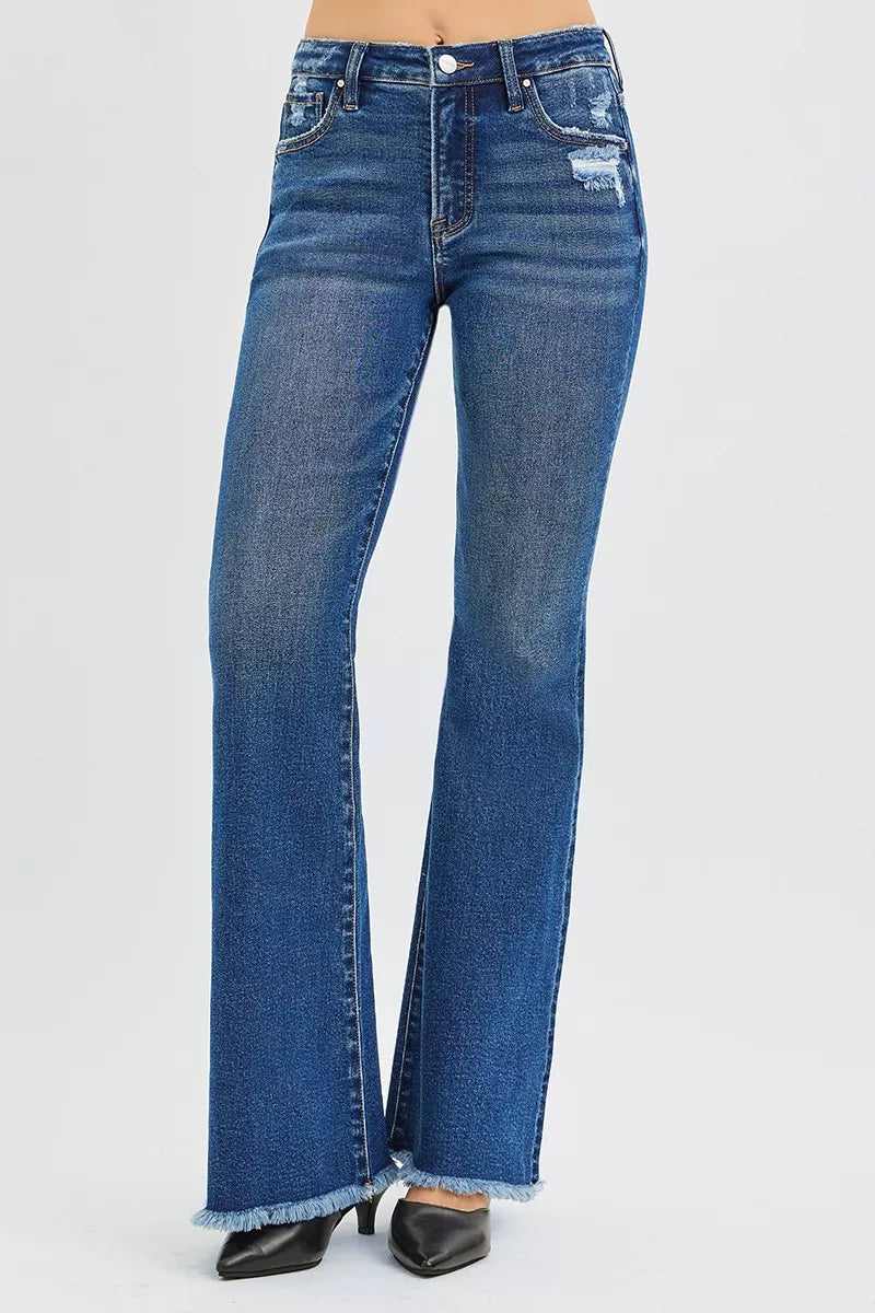 High-rise flare jeans in dark wash denim with frayed hem and subtle whiskering.