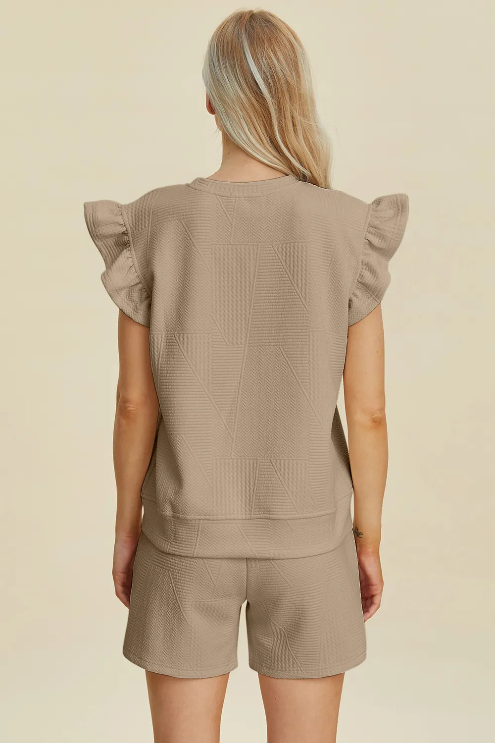 Back view of khaki textured top with ruffle sleeves and matching shorts set