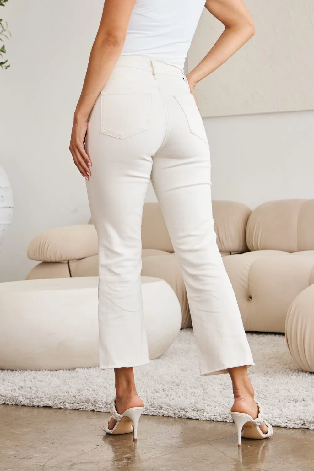 Off-white high-waist jeans with side seams and raw hem, full-length fit