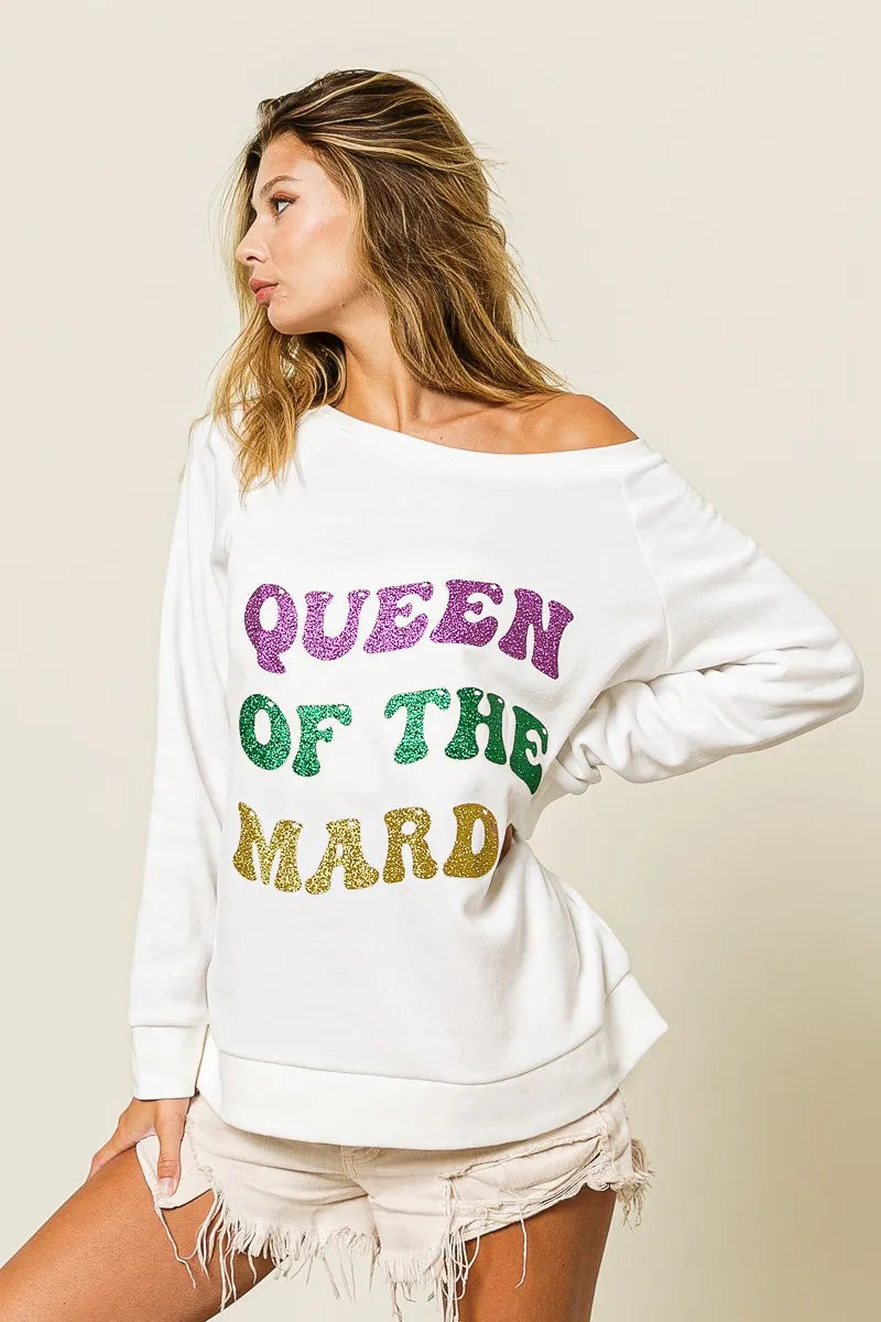 Off-white sweatshirt in side profile with glitter “QUEEN OF TH3 MARDI” print