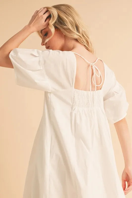 White babydoll dress with square back and tie detail