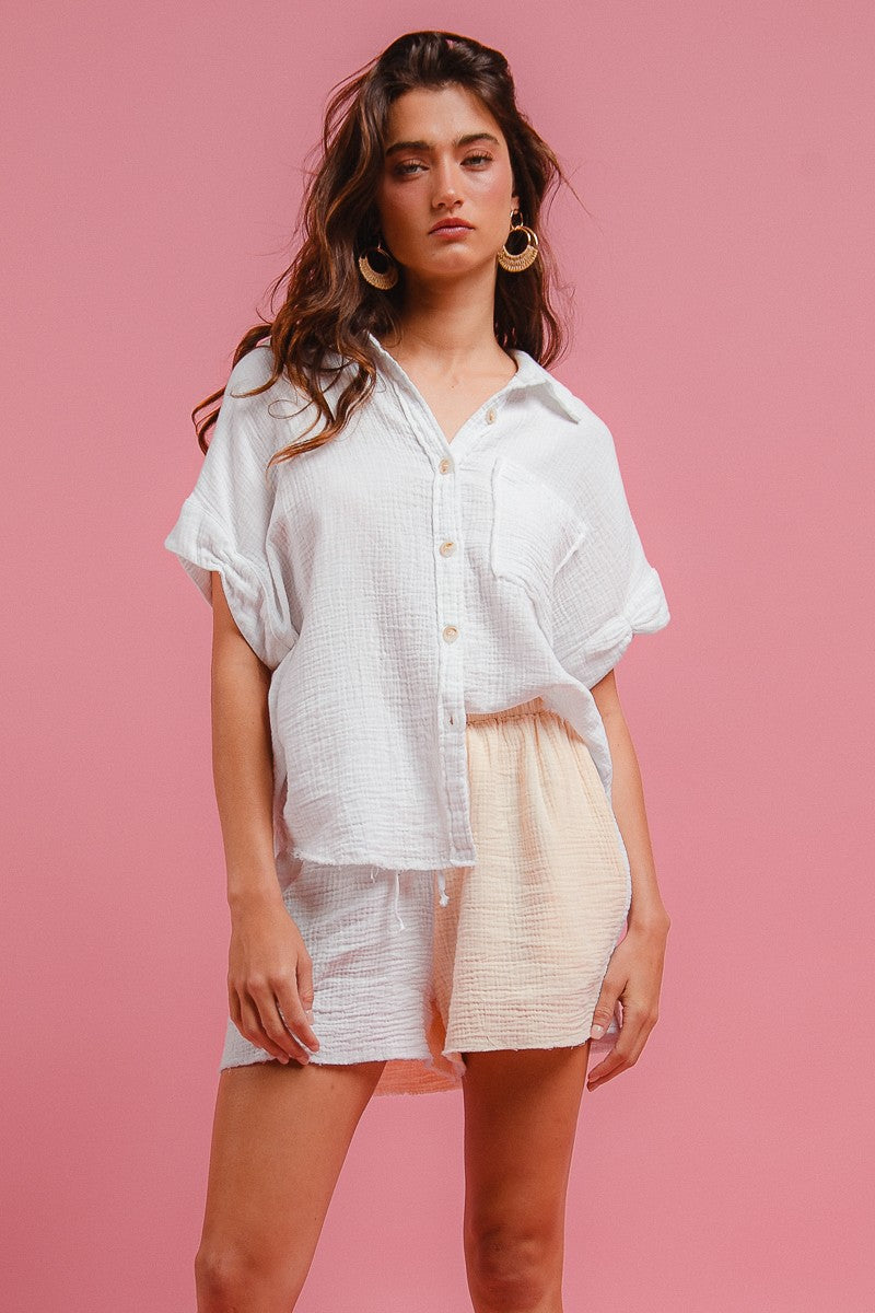 Front view: off-white wrinkled gauze button shirt with chest pocket and matching shorts