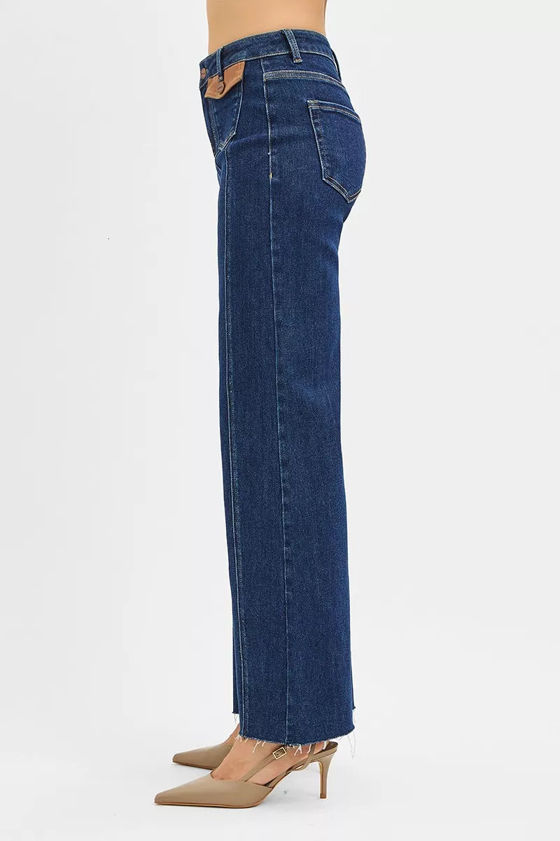 Side view of dark blue high-rise wide flare jeans with leather pocket detail
