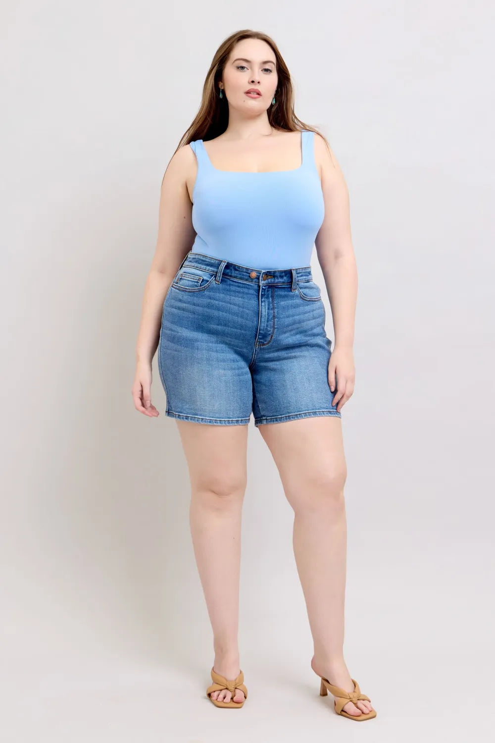Plus size denim shorts in medium wash with two-button front and pockets