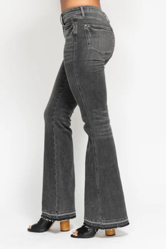 Washed gray mid-rise flare jeans, side-back view with frayed hem and dark stitching