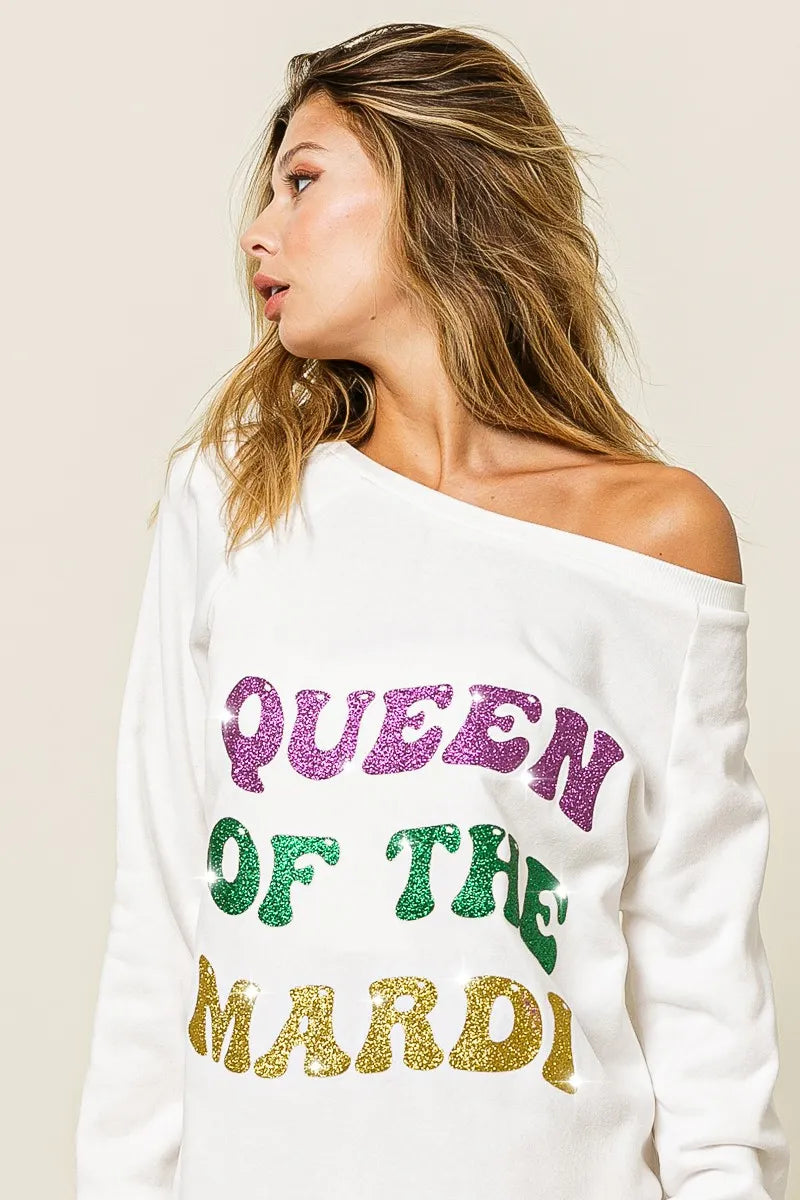 Off-white sweatshirt close-up of glitter “QUEEN OF TH3 MARDI” lettering