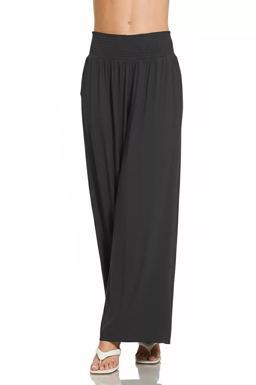 Black wide-leg lounge pants with smocked elastic waist and relaxed straight legs