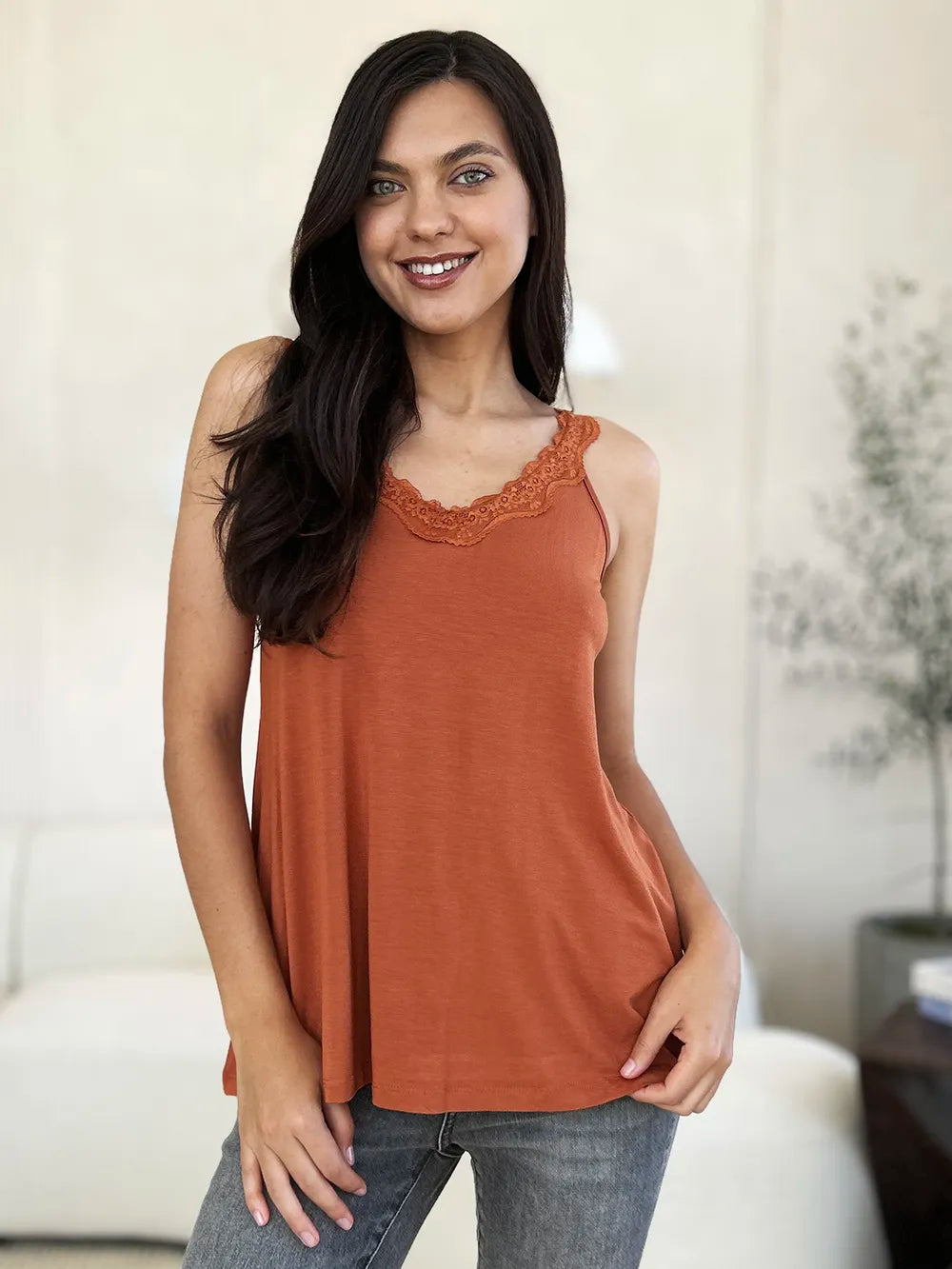 Rust orange camisole with lace neckline trim and flowy drape
