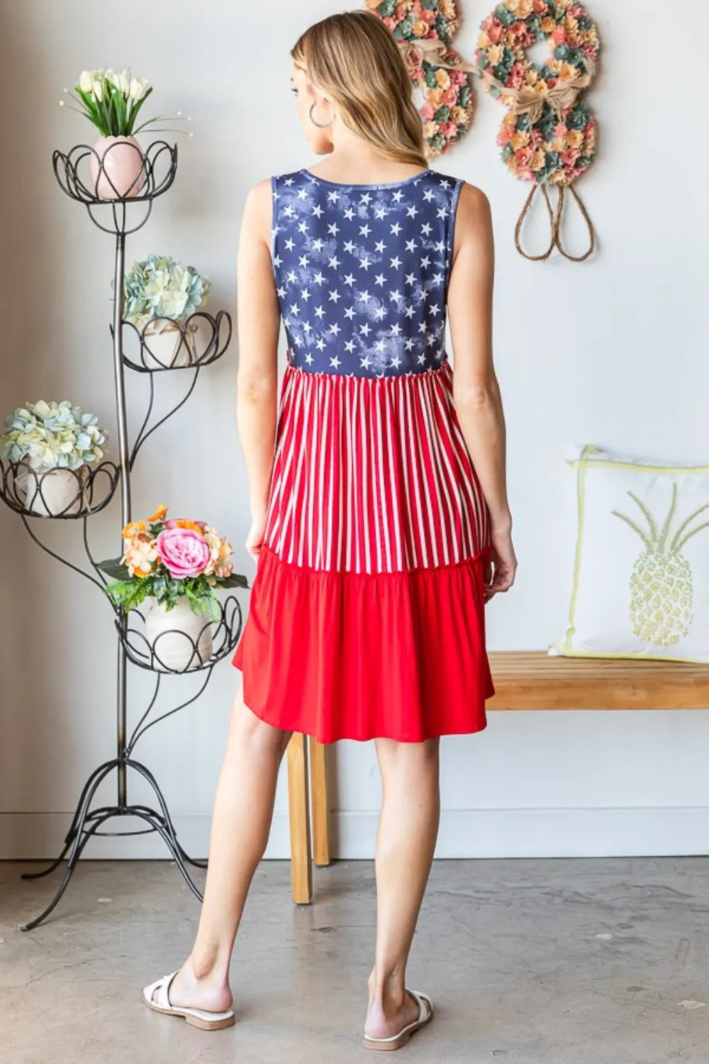 Sleeveless tank dress seen from back: blue star top with red vertical stripe skirt