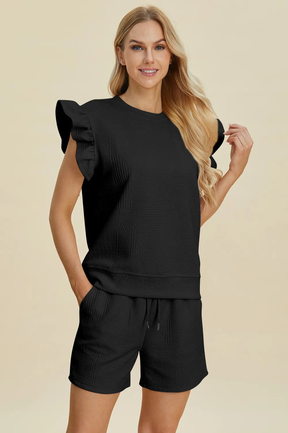 Black textured ruffle sleeve top with drawstring waist shorts, front view