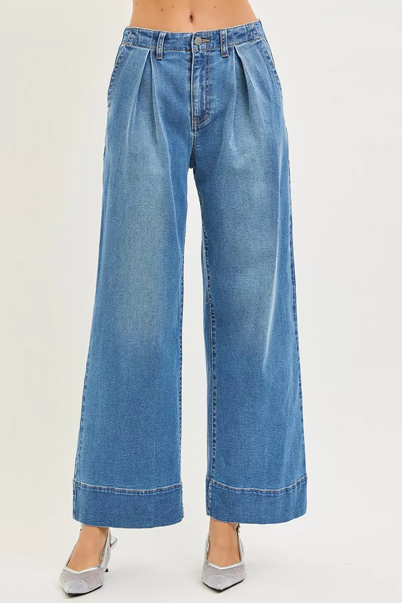 Medium-wash high-rise wide-leg jeans with pleats and button front