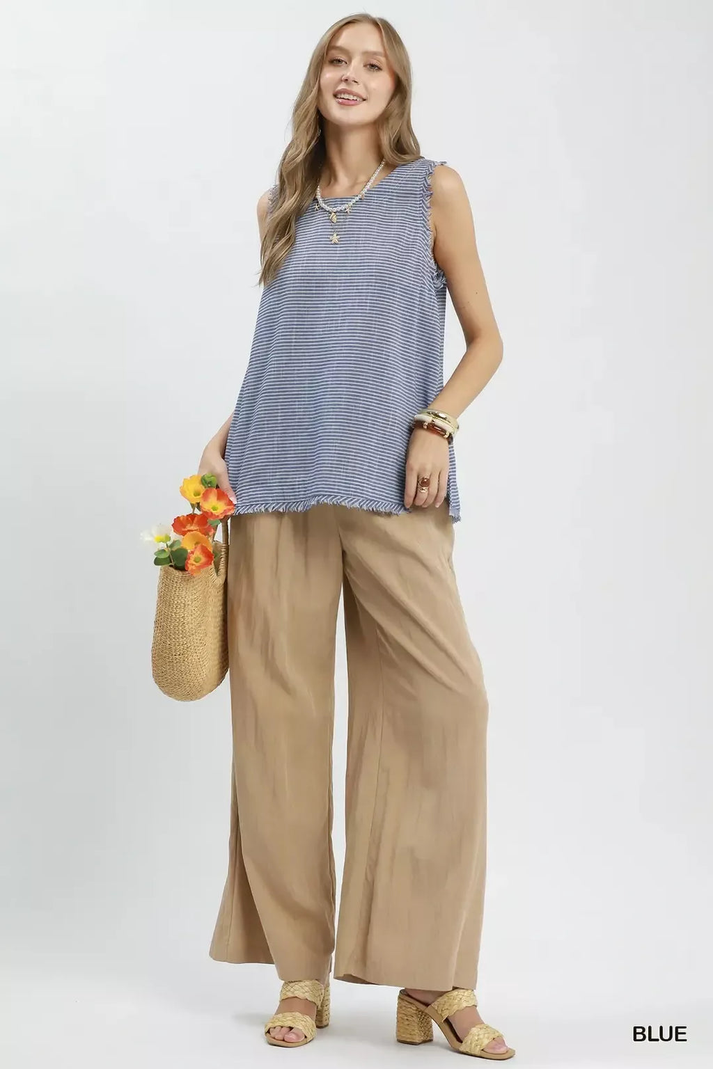 Blue striped sleeveless top with fringe trim at the hemline