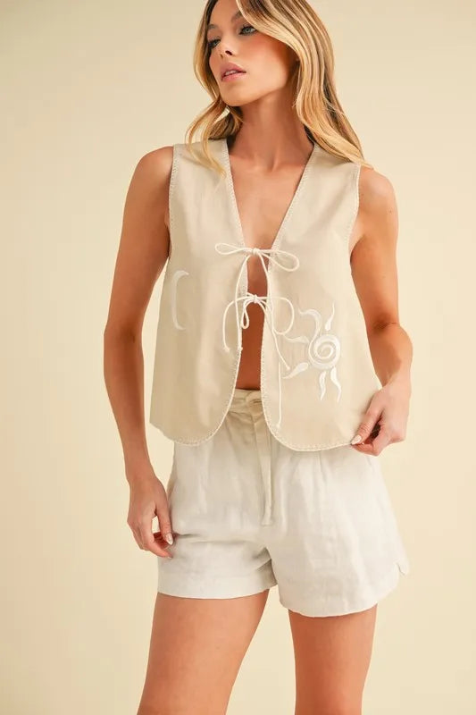 Oat embroidered tied-front vest coat with scalloped hem and lace-up neckline