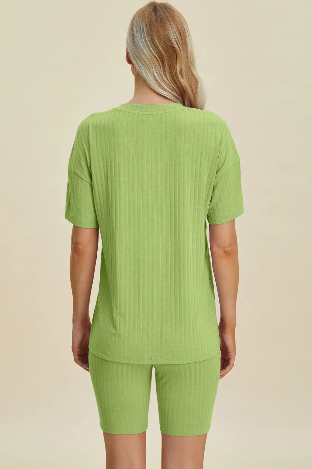 Green ribbed V-neck short sleeve top and matching biker shorts set, back view