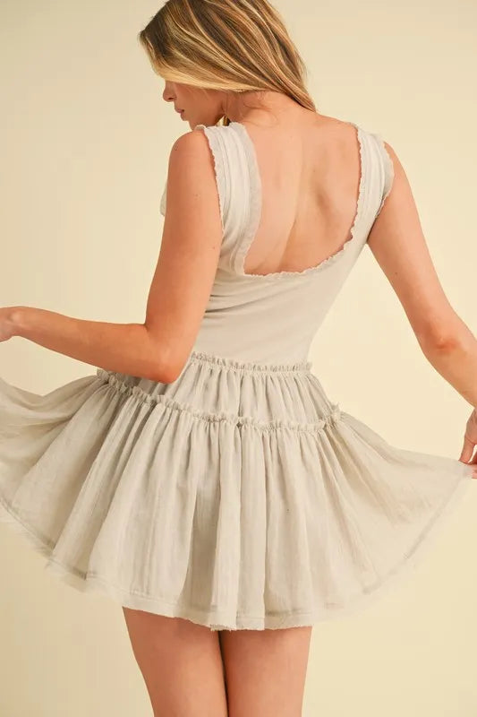 White sleeveless drop-waist mini dress with gathered tiered skirt and scoop back