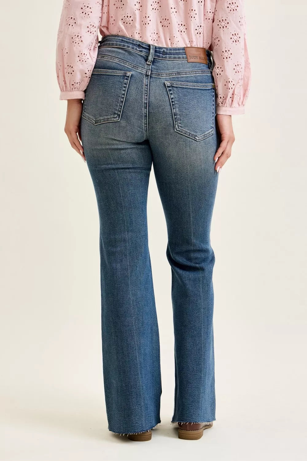Mid-rise flare jeans with front flap pockets, dark wash denim, back view