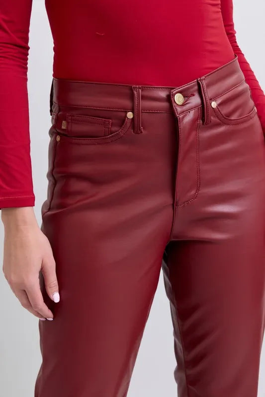 Red high-waist faux leather pants with button waist, belt loops, and front pockets
