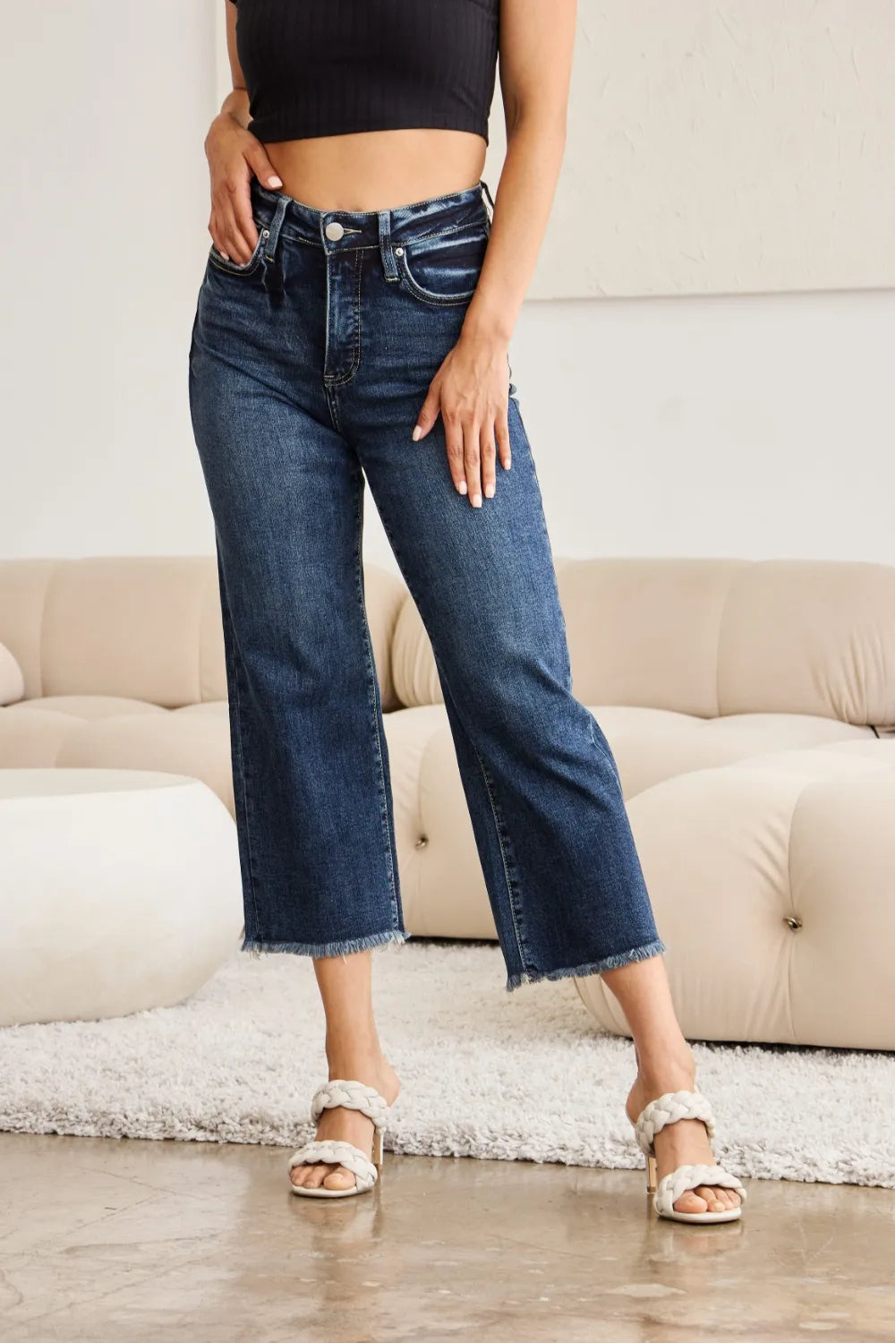 High-waist dark-wash jeans with button fly, front pockets and raw cuff hems