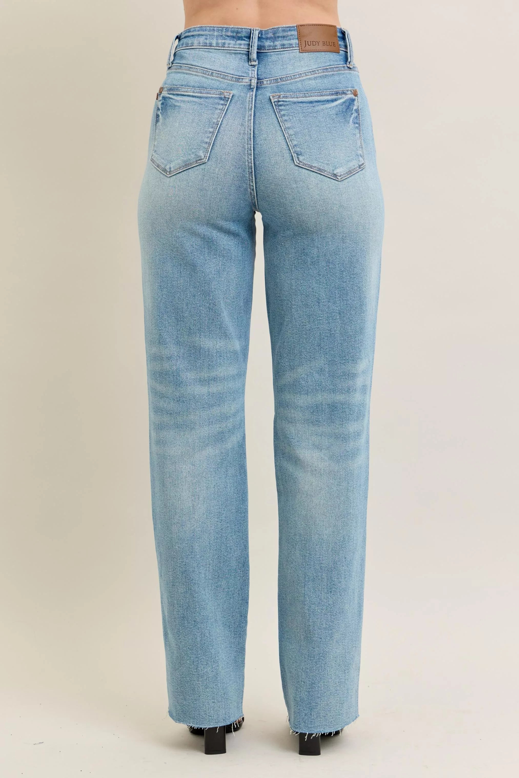 Back view: light-wash jeans with "Judy Blue" waistband label and back pockets