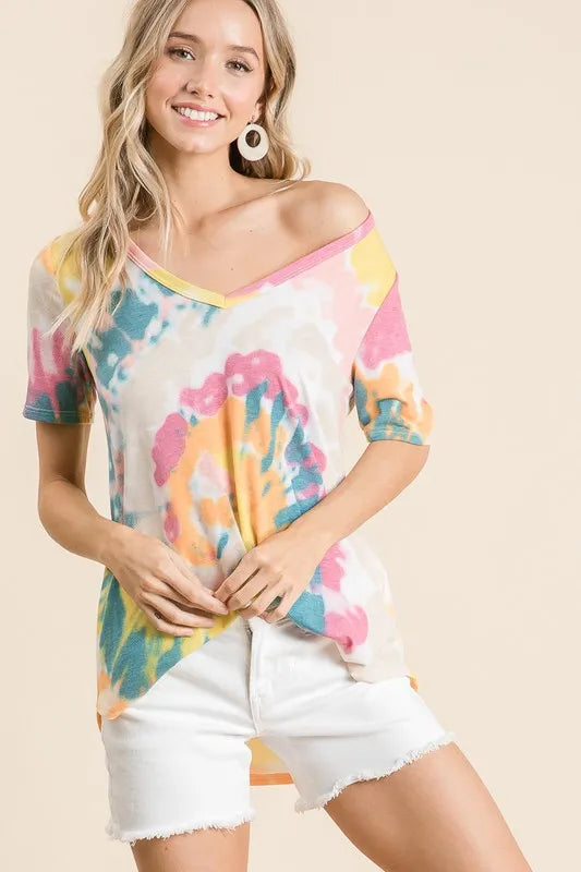 V-neck tie-dye top with yellow-orange, pink, and blue swirls; front hem drapes loosely