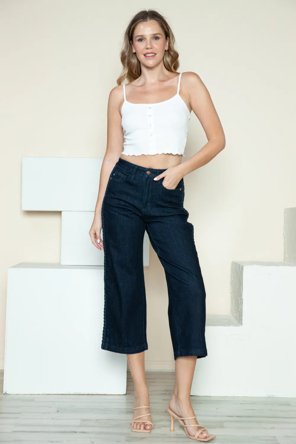 Dark wide-leg crop jeans with front pockets and belt loops; side braid detail