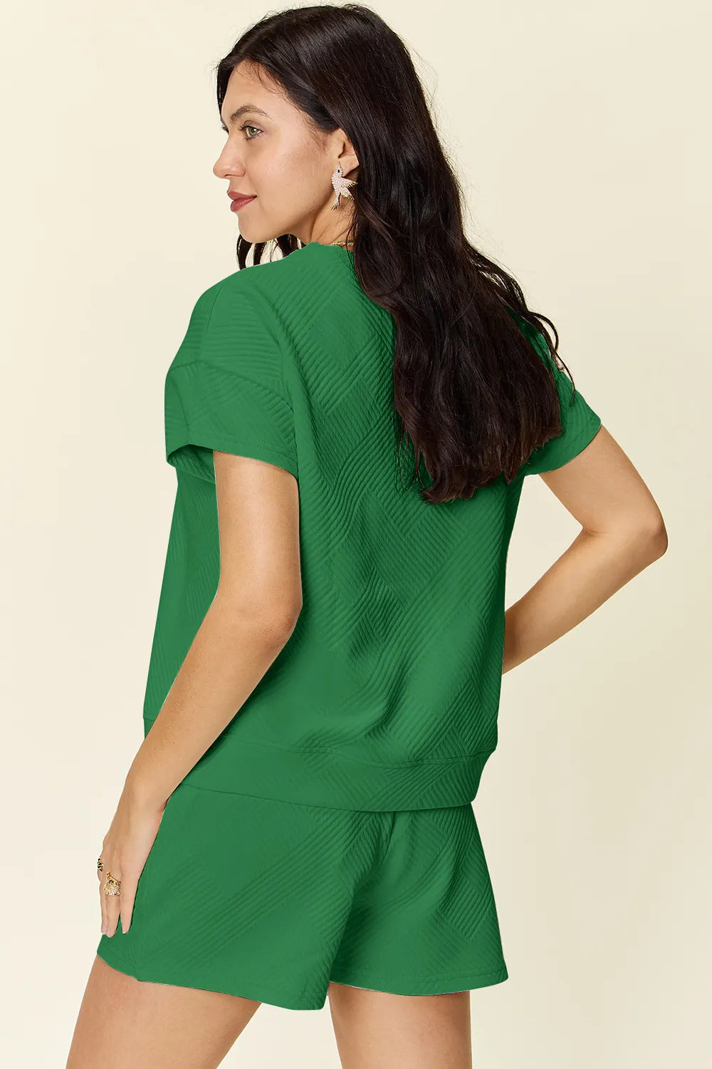 Green textured T-shirt with drawstring waist shorts, angled view