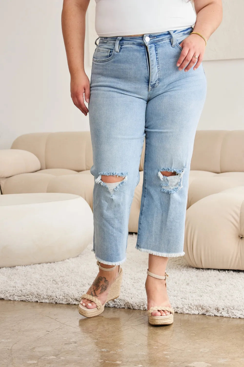 Light wash denim jeans, high rise with raw hem and ripped knees