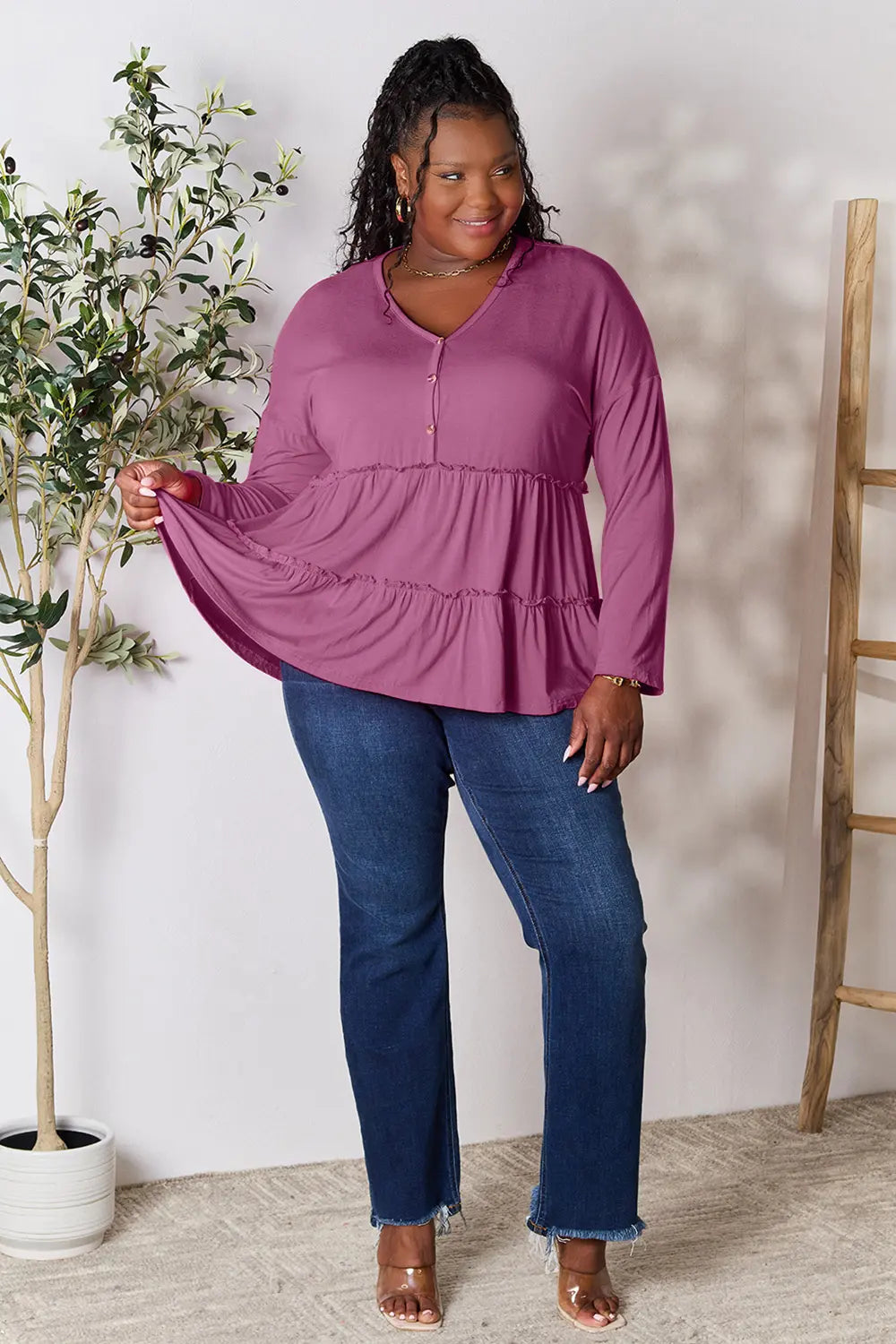 Lilac long-sleeve blouse with half-button front and tiered ruffle hem, side view