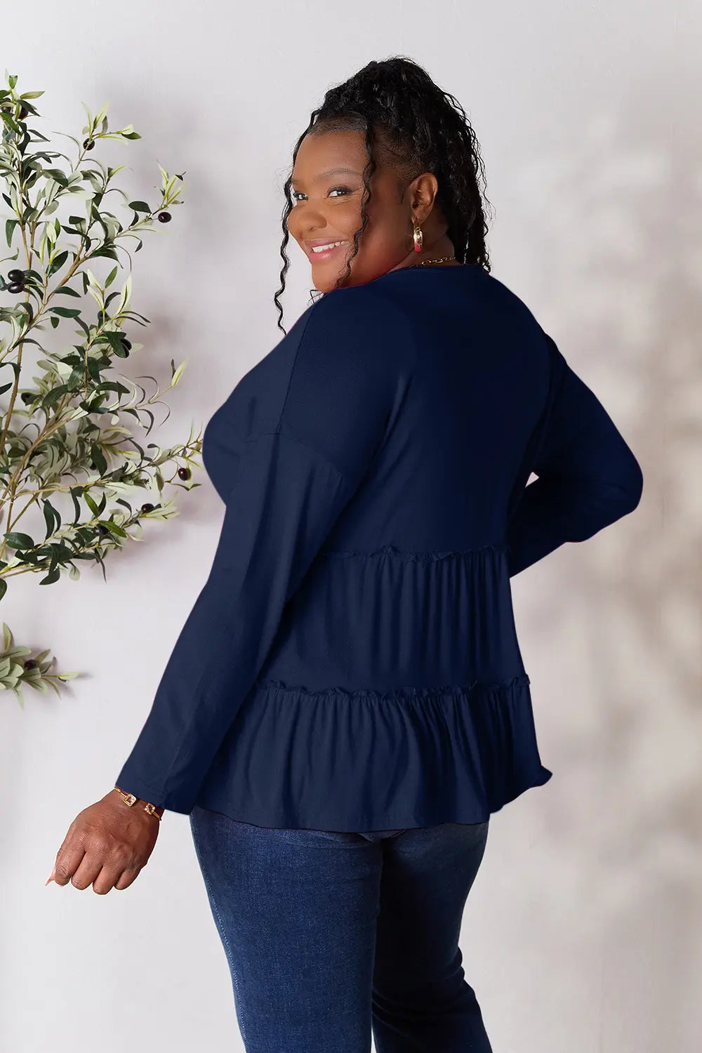 Dark blue long-sleeve blouse back view with tiered ruffle hem