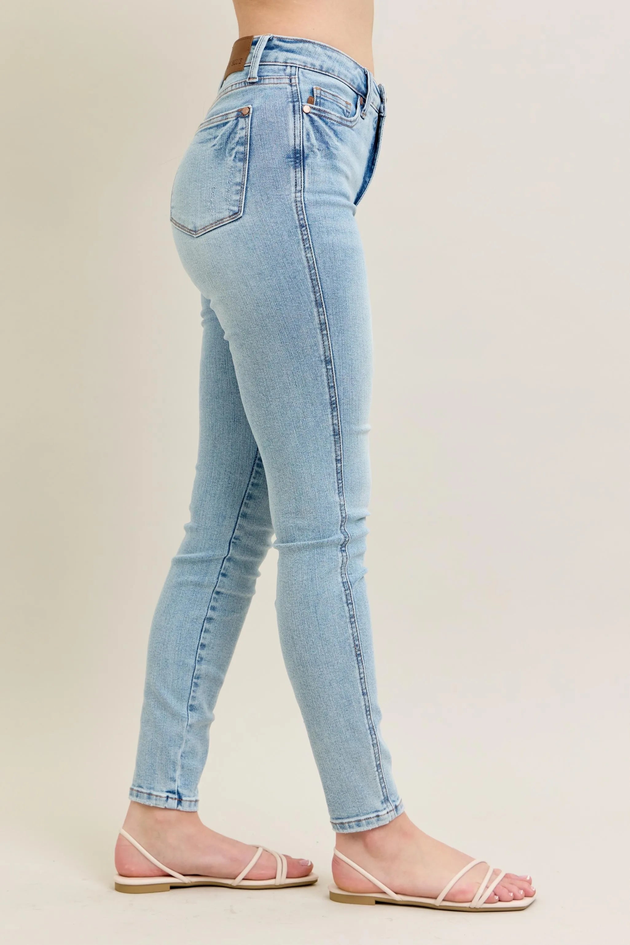 Light wash skinny jeans, back view, high-rise with back yoke and belt loops
