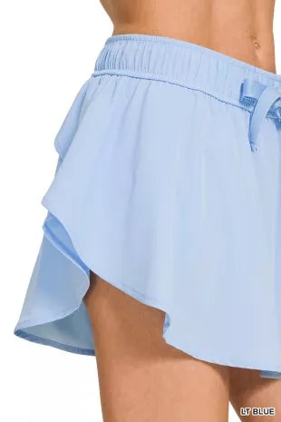 Light blue active skort with flowing side ruffle detail