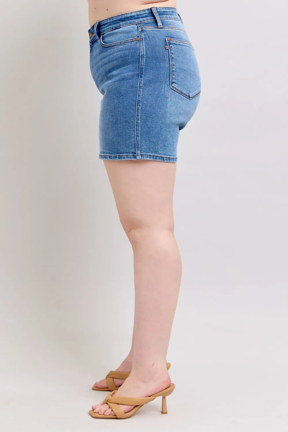 Medium wash denim shorts, back view, with pockets and belt loops