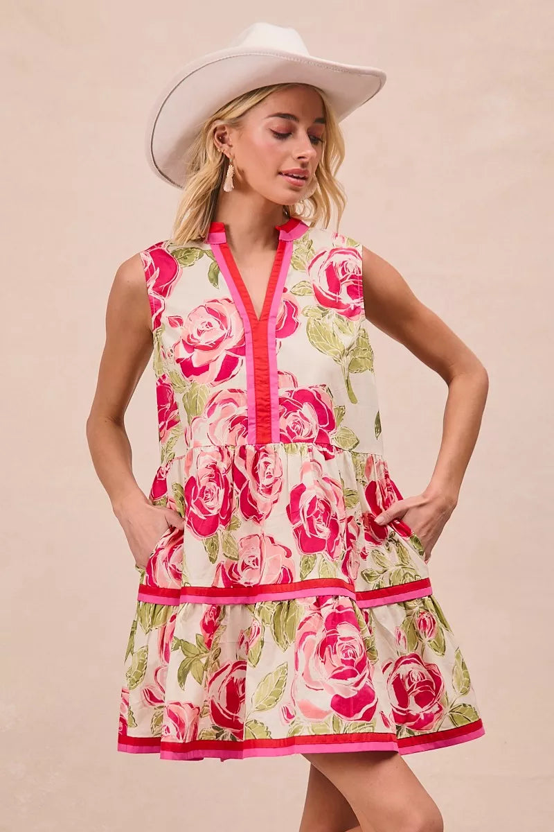 Coral floral mini dress featuring V-neck, buttonless bodice and tiered ruffle layers