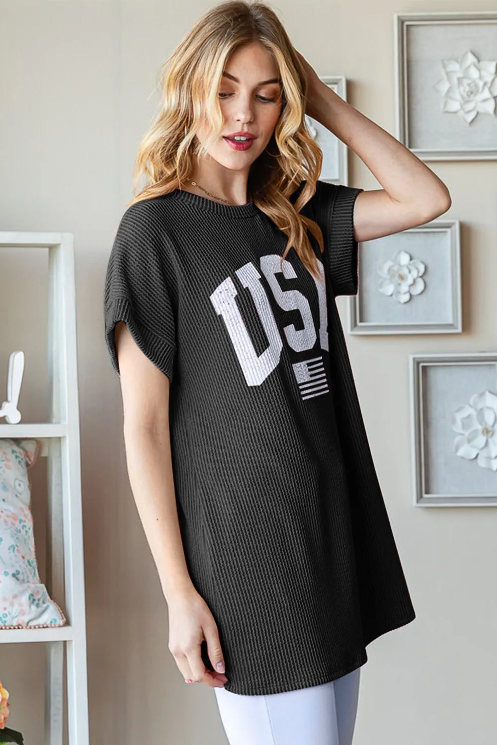Black ribbed short-sleeve top with oversized USA lettering graphic