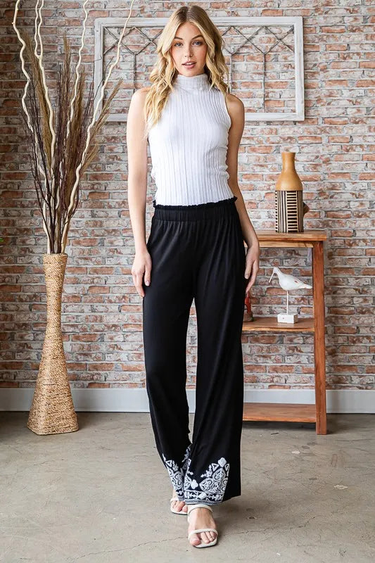 Black wide-leg casual pants with elastic waist and white patterned hem border