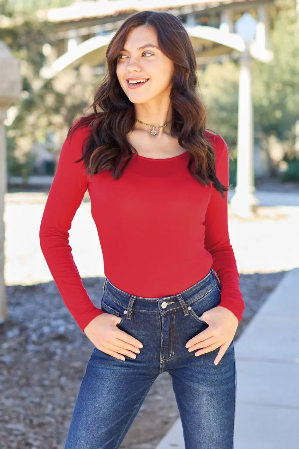 Red long-sleeve round-neck bodysuit with smooth fabric and fitted silhouette.