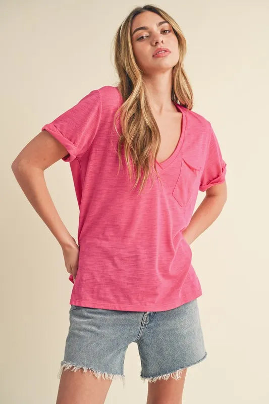 Hot pink V-neck tee with chest pocket and side-slit design, rolled sleeves