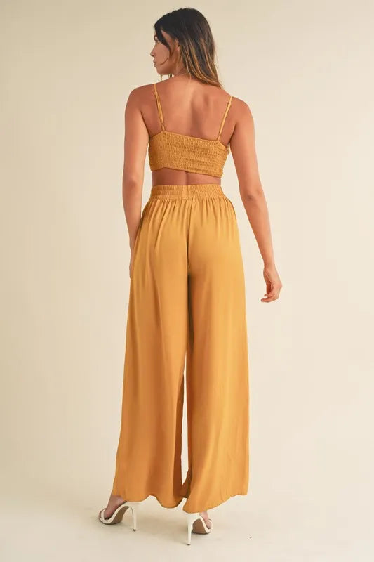 Gold mustard back view: smocked bralette crop top and wide-leg pants with back straps