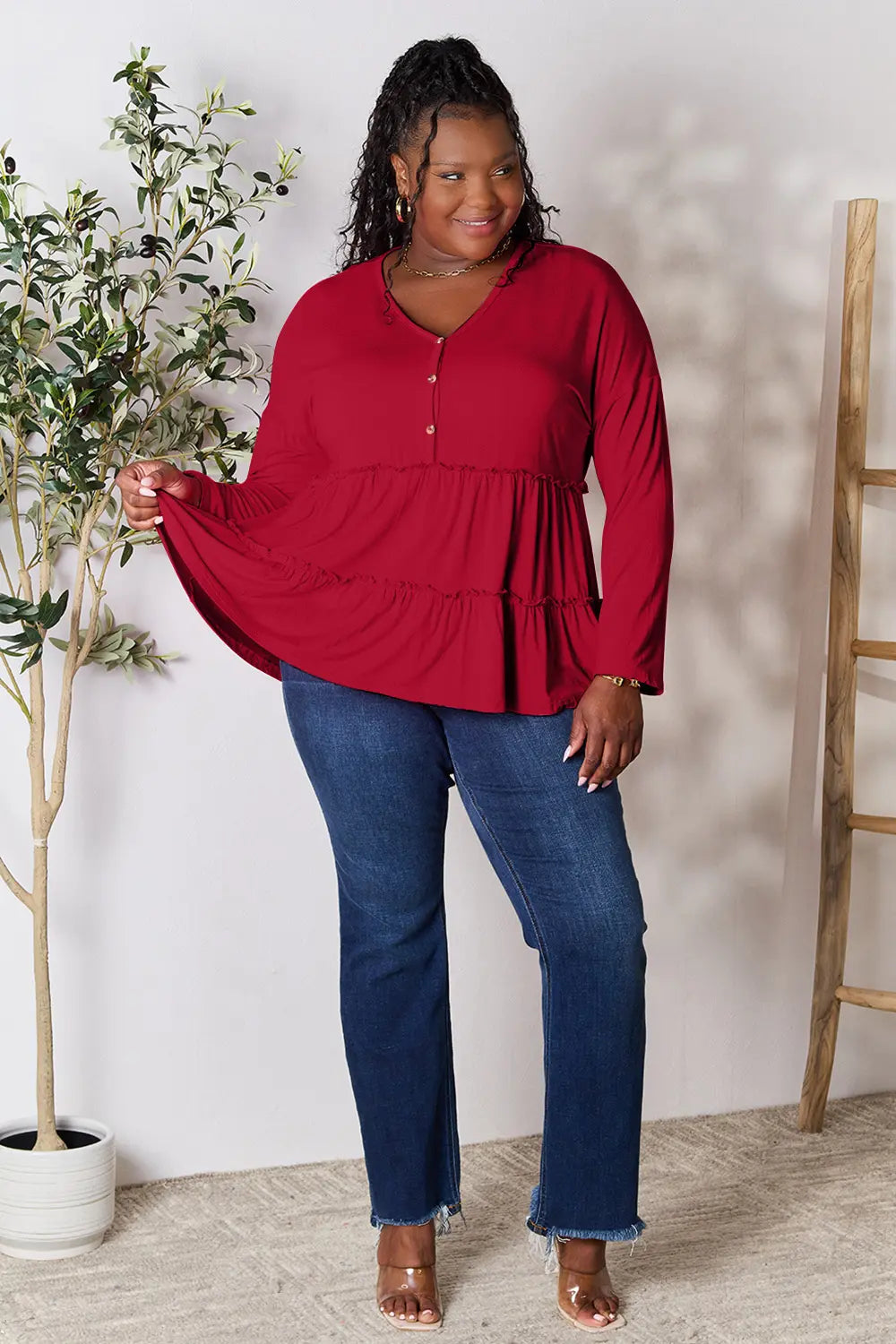 Burgundy long-sleeve blouse with V-neck half-button front and tiered ruffle hem