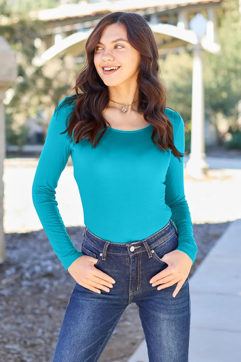 Teal long-sleeve round-neck bodysuit, fitted shape and long sleeves