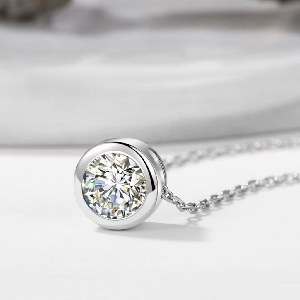 Round moissanite pendant in silver-tone bezel on link chain necklace