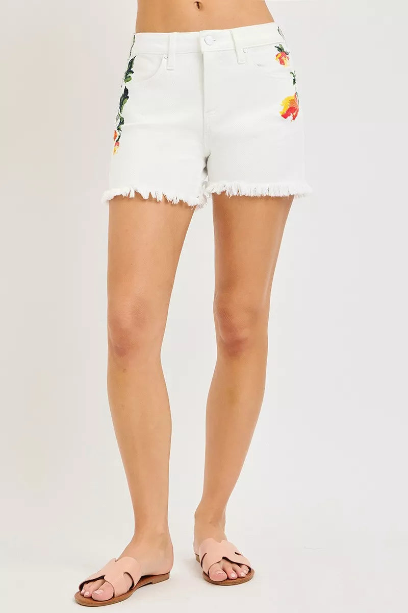 White floral high-rise denim shorts with frayed hem and button front